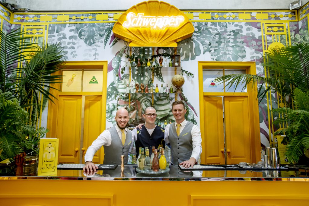 Schweppes event in a bar. Yellow doors and tropical wallpaper in the background